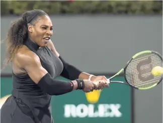  ??  ?? Serena Williams of the United States hits a backhand to Zarina Diyas of Kazakhstan during the first round of the BNP Paribas Open tennis tournament in Indian Wells, California, on Thursday night.