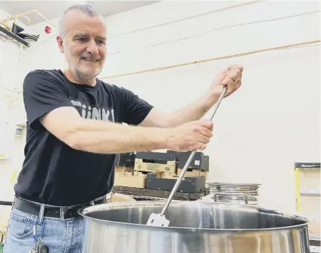  ??  ?? John Chilton making a new batch of Kombucha. Picture by FRANK REID