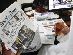  ?? — Photo by Yasser Al-Zayyat ?? KUWAIT: A Kuwaiti man reads yesterday’s issue of Kuwait Times, which bears a headline of the deadly Paris attack that left more than 120 people dead, at his office in Kuwait City.
