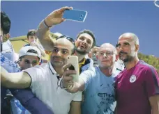  ??  ?? Hassan Kazia, Youssef Badr and Mohammed Hassan pose with City manager Pep Guardiola