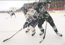  ?? STUART GRADON/FILES ?? The Hitmen’s Jimmy Bubnick, right, and the Pats’ Nathan Macmaster in the first outdoor meeting between the clubs.