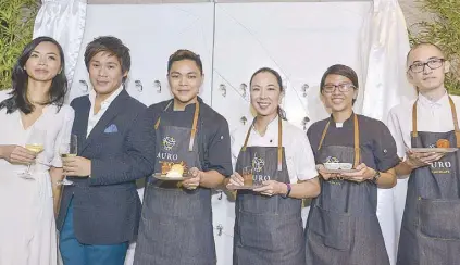  ??  ?? (From left) Auro Chocolate co-managing director Kelly Go and Mark Ocampo with chefs Miko Aspiras, Sunshine Puey, Eliz Tumambing (for chef Peachy Juban) and Richie Manapat.