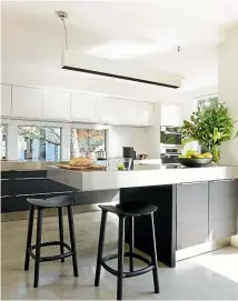  ??  ?? Your dream kitchen won’t be cheap but you can stamp it with your own style by using bold colours, statement pendant lights and furniture.