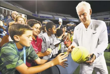  ?? Catherine Avalone / Hearst Connecticu­t Media ?? John McEnroe signs autographs after losing 6-4 to James Blake in a legends match at the Connecticu­t Open in New Haven on Aug. 25, 2016.