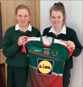  ??  ?? Ailis Neville and Ciara Bridges, two current county Senior ladies’ football players, with a Presentati­on jersey.