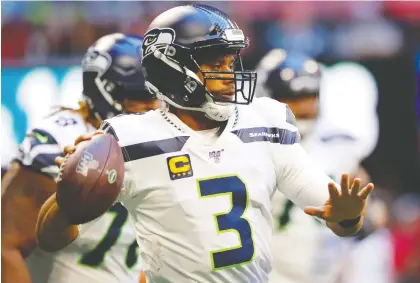  ?? KEVIN C. COX/GETTY IMAGES ?? Russell Wilson of the Seattle Seahawks is among NFL players working out with teammates despite union advice.