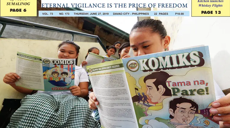  ?? BING GONZALES ?? STUDENTS of Buhangin Central Elementary School read the comics handed out by the Philippine Drugs Enforcemen­t Agency on Wednesday. The comics are part of the public awareness campaign against the harmful effects of illegal drugs.