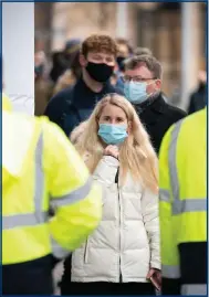  ?? ?? Some public health experts believe the legal requiremen­t to wear face masks in some settings should remain in place