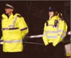  ??  ?? Police officers stand guard beside a cordoned-off area in Salisbury where former double agent Sergei Skripal became critically ill