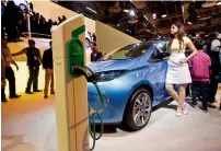  ?? — AFP ?? Non-existent charging infrastruc­ture for electric cars widens the gap between India and China.