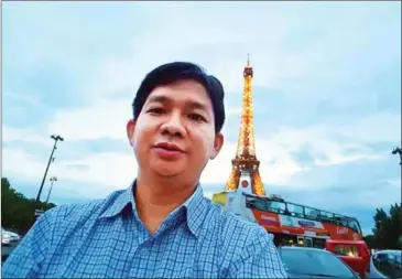  ?? TIENG CHHNOEUM VIA FACEBOOK ?? The champion of the CSX-organised competitio­n – dentist Tieng Chhnoeum – in front of the Eiffel Tower in Paris, France in 2016.