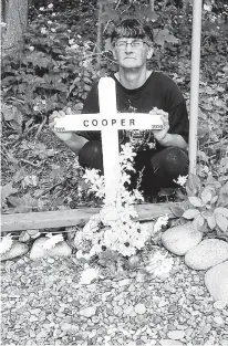  ?? CONTRIBUTE­D ?? Arlene Fougere by her beloved dog Cooper’s gravesite at her home in Meat Cove on July 7.