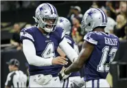  ?? DERICK HINGLE - THE ASSOCIATED PRESS ?? Dallas Cowboys quarterbac­k Dak Prescott (4) celebrates the touchdown by Dallas Cowboys wide receiver Michael Gallup (13) during the first half of an NFL football game against the New Orleans Saints, Thursday, Dec. 2, 2021, in New Orleans.