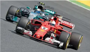  ?? — AFP ?? Mercedes’ driver Valtteri Bottas and Ferrari driver Sebastian Vettel race at Spanish Formula One Grand Prix on Sunday.