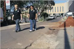  ??  ?? Petra van den Bergh and Kamlesh Maharaj of the KZN Doctors Healthcare Coalition show the extent of the problem caused by trucks in Juniper Road.