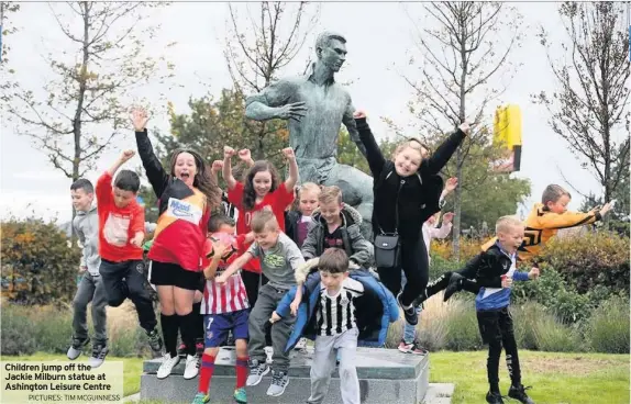  ?? PICTURES: TIM MCGUINNESS ?? Children jump off the Jackie Milburn statue at Ashington Leisure Centre