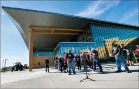  ?? Herald photo by Ian Martens ?? Building maintenanc­e supervisor Clarence Slomp, along with his sons Jordan and Alex, uses an acetylene torch to cut a metal ribbon and officially open the new Trades, Technologi­es and Innovation Facility Wednesday afternoon at Lethbridge College....