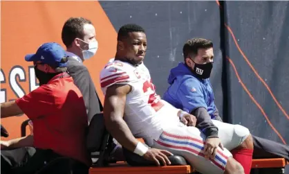  ??  ?? Saquon Barkley is carted to the locker room after being injured during the first half of the New York Giants’ loss to the Chicago Bears. Photograph: Nam Y Huh/AP