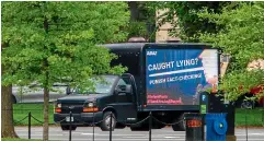  ?? AP ?? A moving billboard with an image of President Donald Trump as Pinocchio circles the White House yesterday in Washington, DC.
