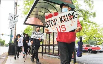  ?? Christian Abraham / Hearst Connecticu­t Media ?? Unidad Latina en Accion holds a black-brown unity march in New Haven Thursday in soliditary with the Black Lives Matter movement to protest police brutality against black people and Latinos.