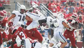  ?? Gary Kazanjian / Associated Press ?? UConn running back Kevin Mensah (34) goes up high for a short gain against Fresno State on Aug. 28.