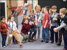  ?? NWA Democrat-Gazette/BEN GOFF •@NWABENGOFF ?? Kindergart­ners through second-graders play “hot potato” during the biweekly “social day” meeting of the Social Homeschool­ers Network of Northwest Arkansas at the First Baptist Church of Rogers’ Olive Street Campus.