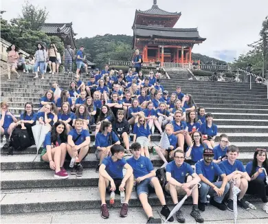  ??  ?? Take a break The young musicians relax after a visit to the Kyoto temple, umberellas at the ready