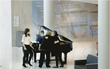  ?? ?? Calcagno plays the piano for staff and volunteers in the lobby area at Advocate Good Shepherd Hospital in Barrington.