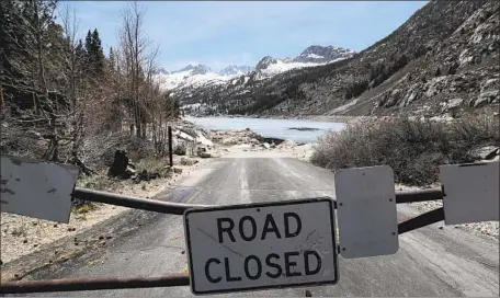  ?? Photograph­s by Brian van der Brug Los Angeles Times ?? THE ROAD to South Lake was closed in early May near Bishop, where the fishing season had been postponed along with tourist dollars.
