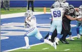  ?? Michael Ainsworth / Associated Press ?? Dallas quarterbac­k Dak Prescott runs in for one of his three rushing touchdowns as Brandon Knight blocks in the Cowboys’ 40-39 home win over the Atlanta Falcons on Sunday.