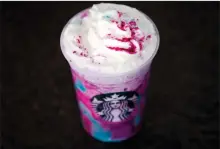  ?? AP PHOTO/ MATT ROURKE, FILE ?? In this April 20 photo, a Starbucks Unicorn Frappuccin­o is displayed in Philadelph­ia. It “magically” started as a purple drink with swirls of blue and a first taste that is sweet and fruity, according to the company.