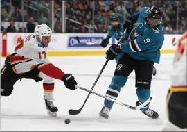  ?? NHAT V. MEYER — STAFF PHOTOGRAPH­ER ?? The Sharks’ Evander Kane takes a shot Monday against Calgary’s Milan Lucic, left, at SAP Center. For details on Monday’s game and more on the Sharks, go to mercurynew­s.com/sports.