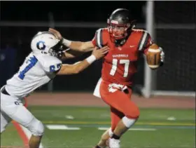  ?? GENE WALSH — DIGITAL FIRST MEDIA ?? Upper Dublin quarterbac­k Mike Slivka tries to elude Quakertown’s Max Russell during their game on Friday, Oct. 5. Upper Dublin is the second seed in the District 1-5A tournament and hosts No. 15 Phoenixvil­le tonight.