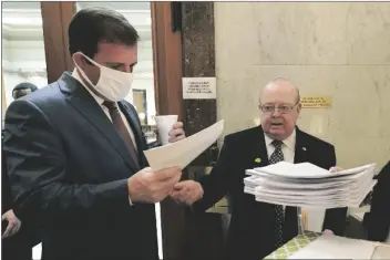  ?? ROGELIO V. SOLIS – STAFF, AP ?? THIS MARCH 2 PHOTO SHOWS Mississipp­i Senate Finance Committee Chairman Josh Harkins (left) reviewing a number of proposed bills with Senate Accountabi­lity Efficiency and Transparen­cy Committee Chairman John Polk at the Capitol in Jackson, Miss.