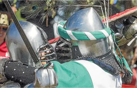  ?? WARWICK SMITH/STUFF ?? Denny Denski, left, and Scott Engebretse­n get up close and personal during the swordplay at the Levin medieval market.