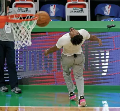  ?? StUart cahILL phOtOs / heraLd staFF ?? FEELING BETTER: Celtics glue guy Marcus Smart attempts one of his patented backward 3-pointers during warmups on Tuesday night at the Garden. Below, Celtics rookie wingman Aaron Nesmith battles with Pacers guard Aaron Holiday for a loose ball on Friday.