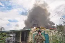  ?? LIBKOS/ASSOCIATED PRESS ?? A Ukrainian soldier passes by a burning house after the Russian shelling close to the front line in Seversk, Donetsk region, Ukraine, Friday.