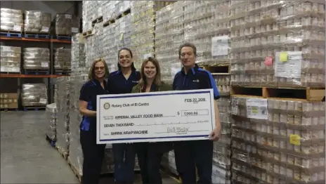 ??  ?? FROM LEFT: El Centro Rotary Club members Kathy Ball, club President Kris Becker and Lee Hindman present a symbolic $7,000 check for a shrink-wrap machine to Imperial Valley Food Bank Executive Director Sara Griffen (second from right). COURTESY OF THE...