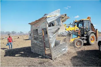  ?? Picture: MARK ANDREWS ?? HEARTBREAK­ING: Complete and unfinished housing structures at Ententeni, behind the EL Airport, were demolished in June.