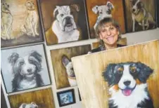  ?? Hyoung Chang, The Denver Post ?? Artist Andy Mallen of Canvas Canines with some of her custom pet portraits.