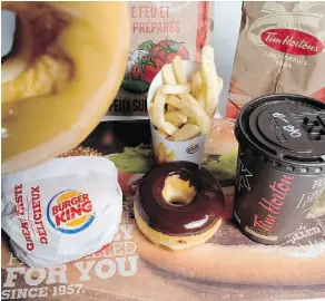  ?? JONATHAN HAYWARD/THE CANADIAN PRESS/FILE ?? Parent company Restaurant Brands Internatio­nal is rapidly growing Burger King and Tim Hortons locations. Tim Hortons now has more than 4,700 locations worldwide.