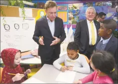  ?? Erik Trautmann / Hearst Connecticu­t Media ?? Gov. Ned Lamont, left, and Norwalk Mayor Harry Rilling tour a Tracey Elementary School science lab with the help of fifth-grader Adrien Danso, right, on Jan. 16 prior to a roundtable discussion hosted by the Dalio Foundation at the school in Norwalk.