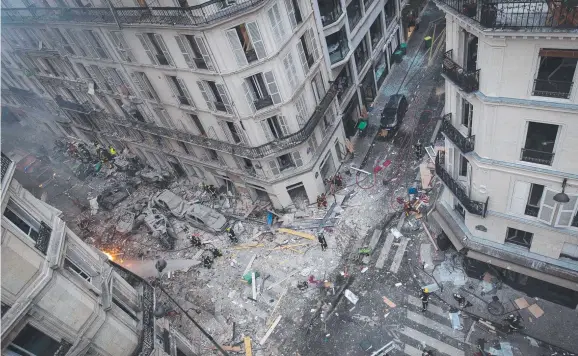  ?? Picture: AFP/CARL LABROSSE ?? GRIM SCENE: Debris and car wreckage following the explosion of a bakery in central Paris