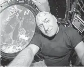  ?? SCOTT KELLY VIA AP ?? In the ultimate out-of-thisworld selfie, Astronaut Scott Kelly takes a photo July 12, 2015, inside the Cupola, a special module of the Internatio­nal Space Station with a 360-degree viewing of Earth and the station.