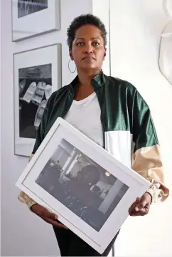  ?? CARL JUSTE cjuste@miamiheral­d.com ?? Photograph­er Johanne Rahaman pulled her exhibit from the HistoryMia­mi museum over what she perceives as a culture of racism. Rahaman holds one of the 173 photograph­s she had selected for the show.