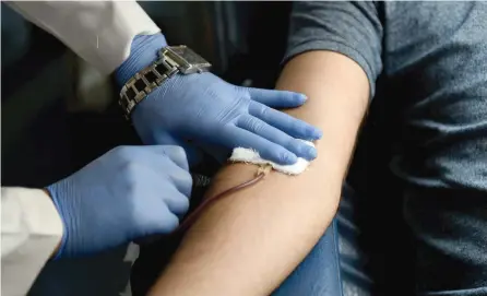  ?? — AFP ?? A man donates blood at a camp organised by the Rotary Blood Bank in New Delhi.