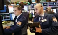  ?? THE ASSOCIATED PRESS ?? Anthony Rinaldi, left, and Fred DeMarco follow stock prices, Thursday at the New York Stock Exchange.