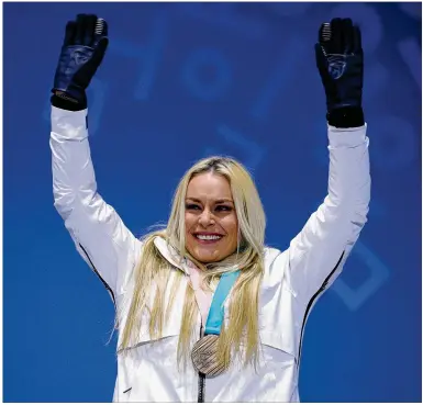  ?? ANDREAS RENTZ / GETTY IMAGES ?? Lindsey Vonn of the U.S. celebrates during the medal ceremony Wednesday after winning bronze in the downhill. She races again Thursday but knows it would take a miracle for her to win another medal.