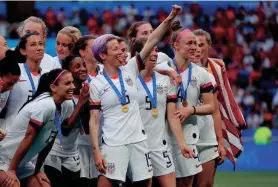  ?? ?? United States forward Megan Rapinoe (15) and teammates celebrate after defeating the Netherland­s in the championsh­ip match of the 2019 FIFA Women’s World Cup. Rapinoe has continued her pay equity work after leaving the pitch.