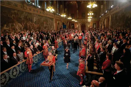  ?? The Associated Press ?? Prince Charles, Camilla, Duchess of Cornwall, and Prince William proceed behind the Imperial State Crown through the Royal Gallery for the State Opening of Parliament at the Palace of Westminste­r in London, Tuesday.